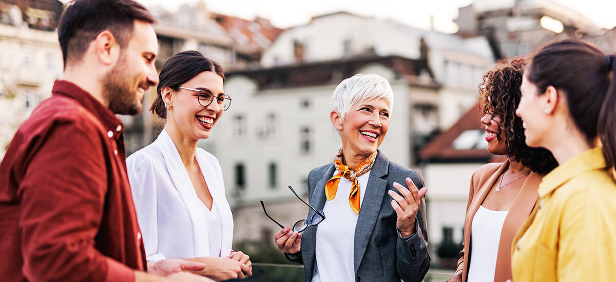 Business colleagues on a terrace talking to each other about hearing loss