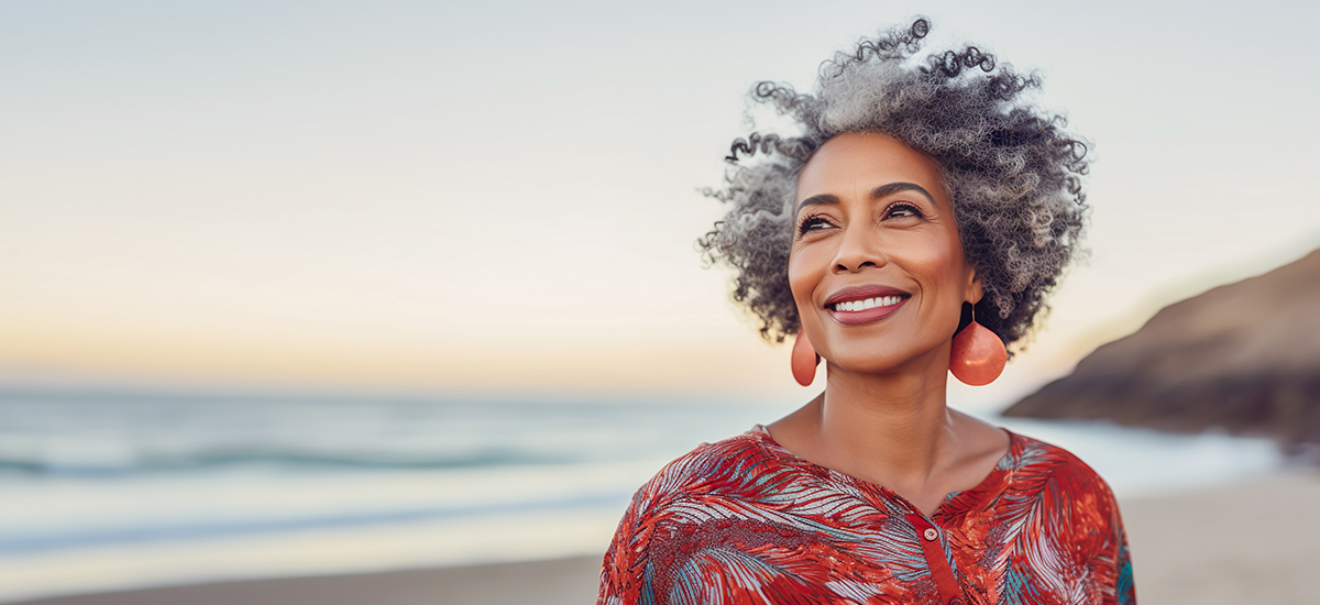 Mature woman on beach smiling with good hearing