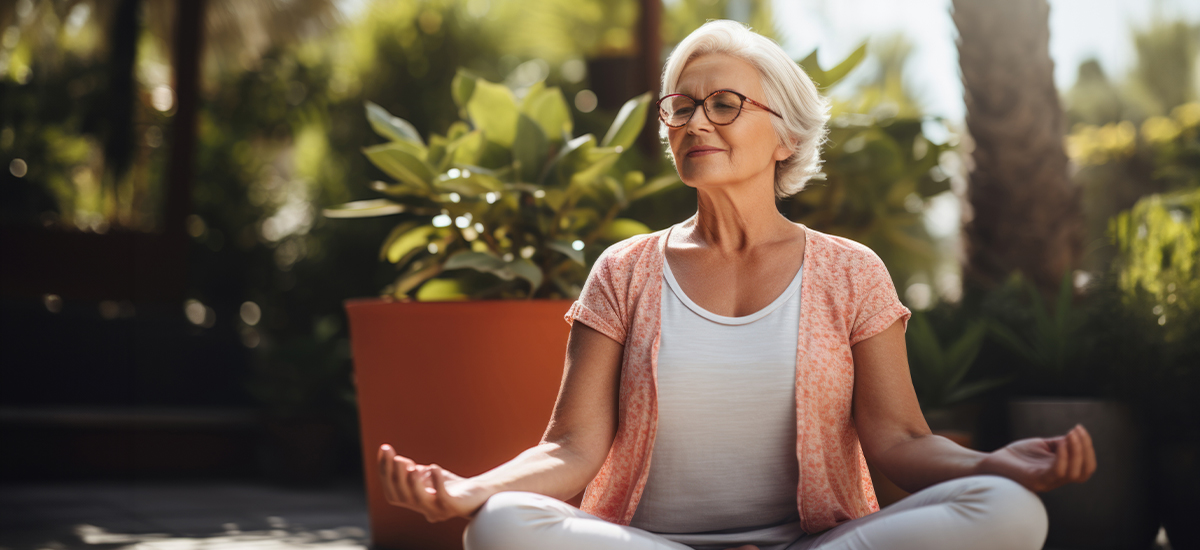 Mature woman using mindful meditation to help her tinnitus symptoms