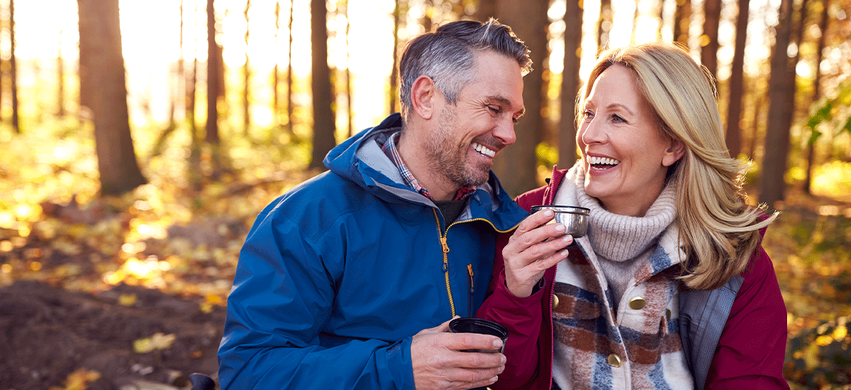 mature women and their partners hiking and discussing hearing loss treatments